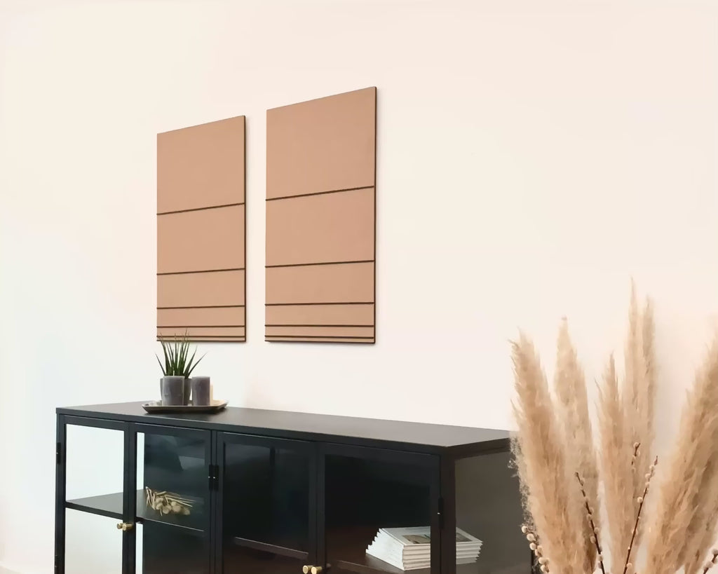 Frau hängt hochwertiges 3D Wandbild in der Farbe beige und schwarz aus Filz und Holz im Wohnzimmer auf